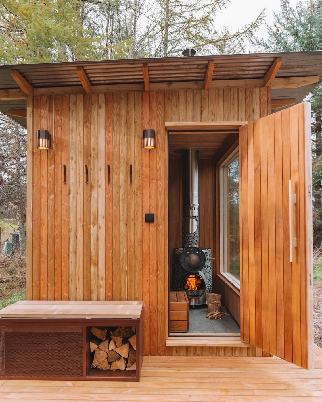 Sauna with door open and stove lit